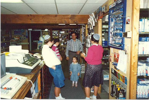Glen & family behind counter